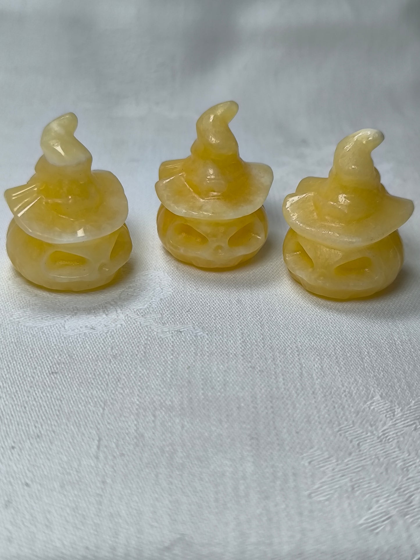 Yellow calcite pumpkins wearing hats