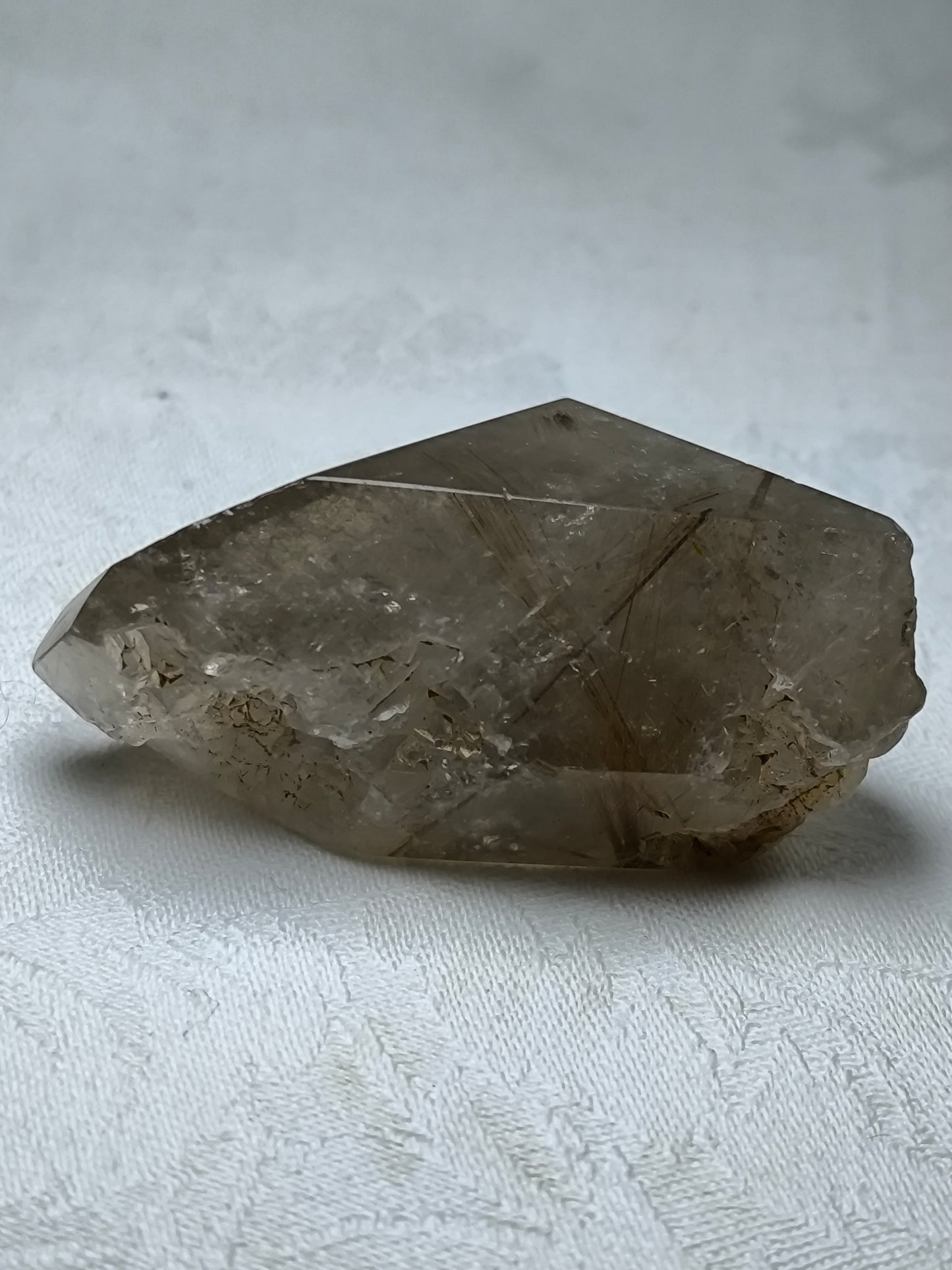 Part polished smoky quartz with rutile