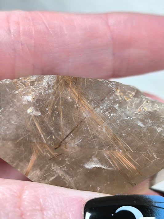 Part polished smoky quartz with rutile