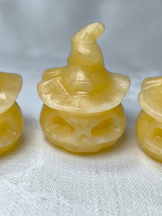 Yellow calcite pumpkins wearing hats