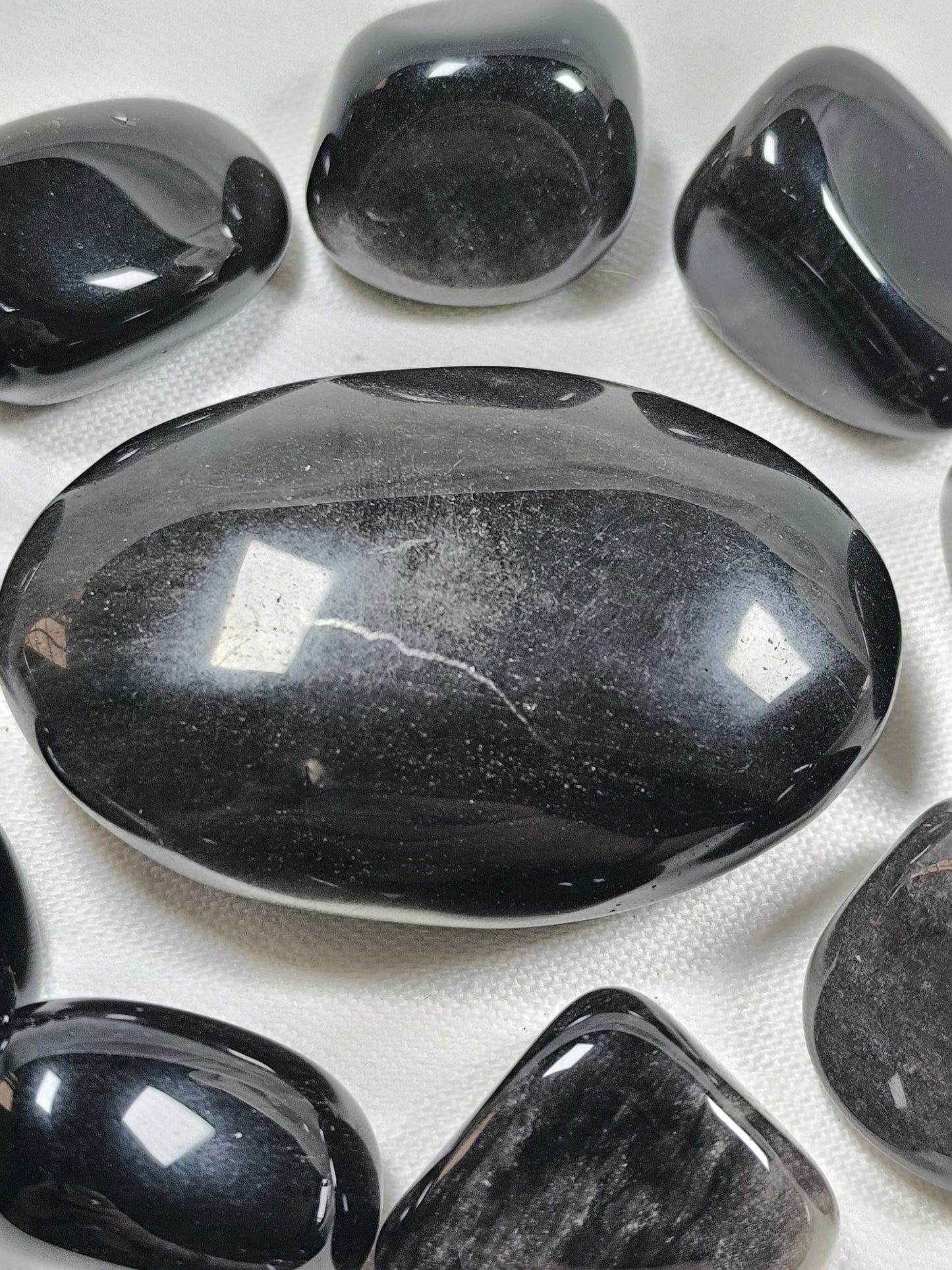 Silver sheen obsidian palm stone
