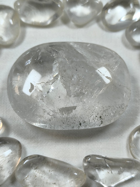 Clear quartz palm stone with chlorite inclusions